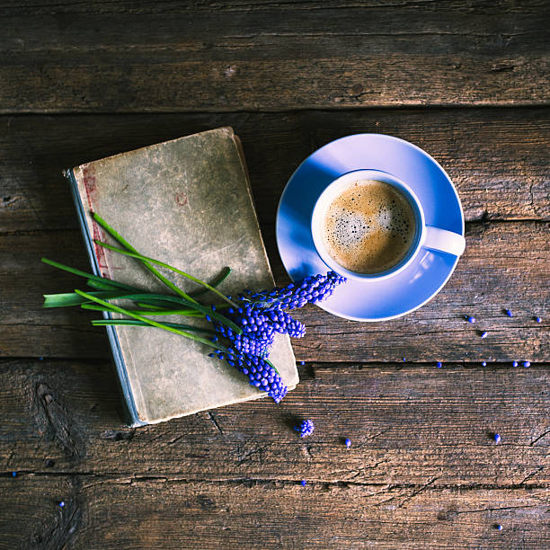istock Blue flowers and a cup of coffee with a book 534128772