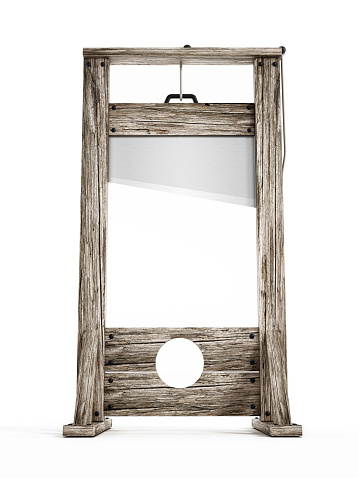 Old wooden guillotine isolated on white.