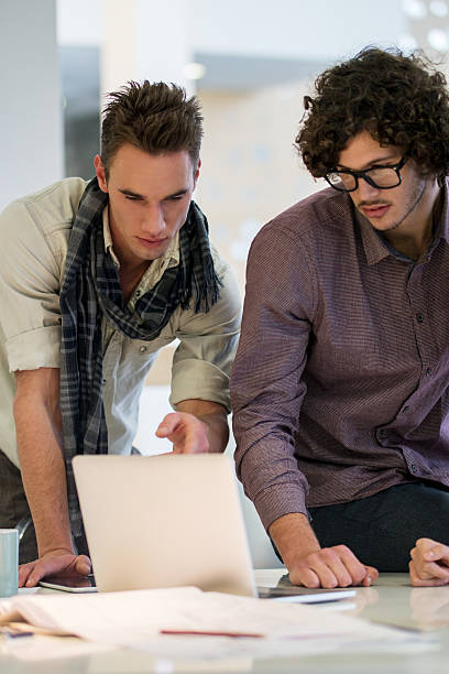 istock Young modern businessmen using laptop in the office. 534130474