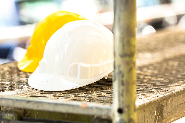 istock Safety helmets, one white the other yellow, on scaffolding 534130670
