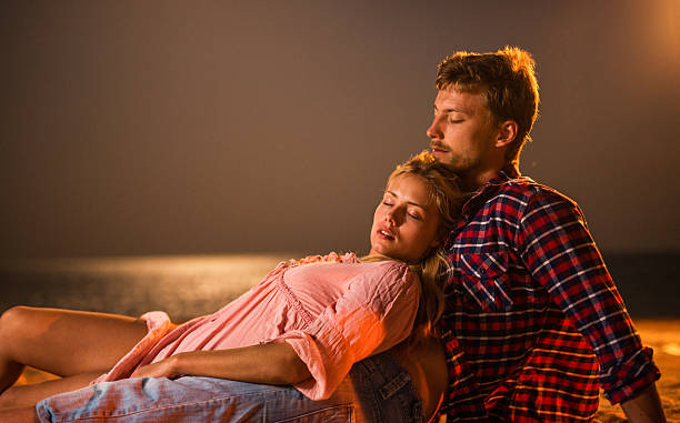 istock Couple resting on the beach at night. 534131341