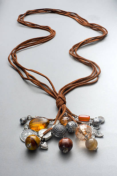 istock Several necklaces knotted together on gray 534131502