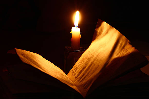 istock concept of knowledge, vintage book candle 534131631