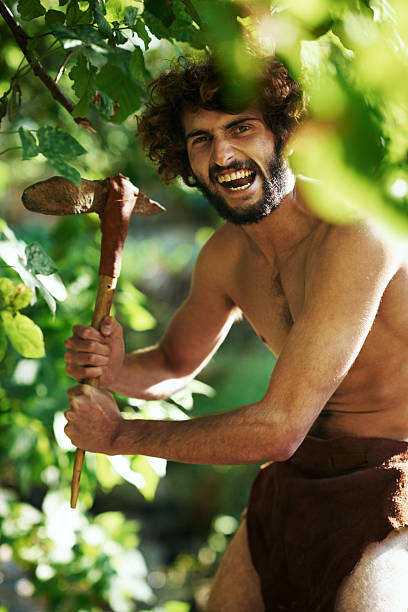 Time for hunting An aggressive caveman holding an axe loin cloth stock pictures, royalty-free photos & images