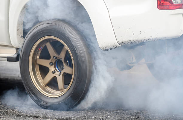 car burnout car burnout at a drag racing track car burnout stock pictures, royalty-free photos & images