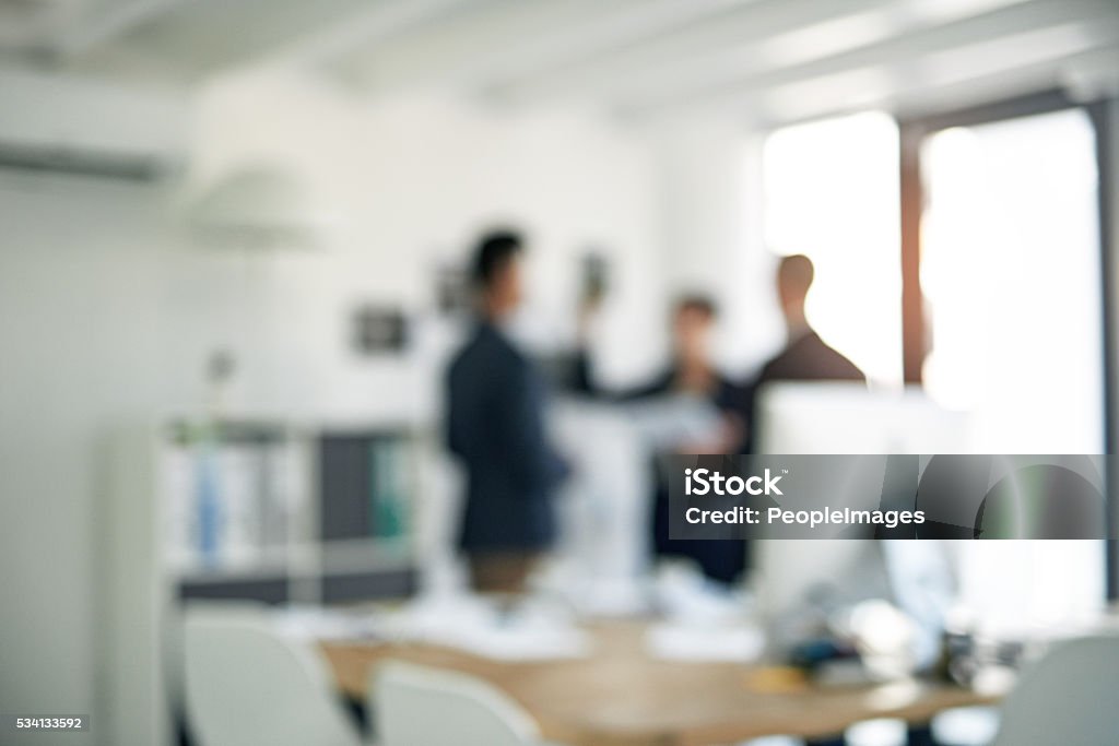 There's a lot that goes on in the background Cropped shot of three colleagues working in the office Office Stock Photo