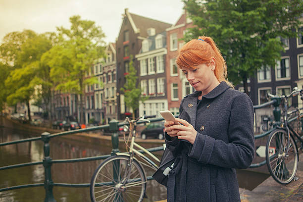 istock Happy girl using a smart phone in Amsterdam Streets 534134180