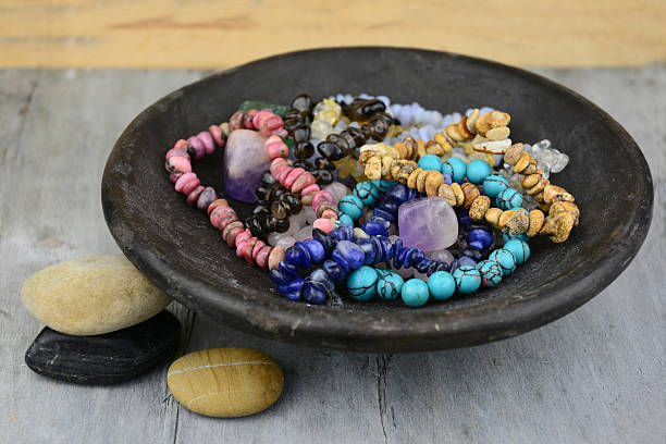 gemstones and crystals decorated in old earthenware dish on wood