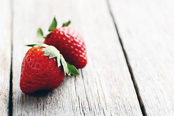 istock Ripe red strawberry on a grey wooden table 534135098