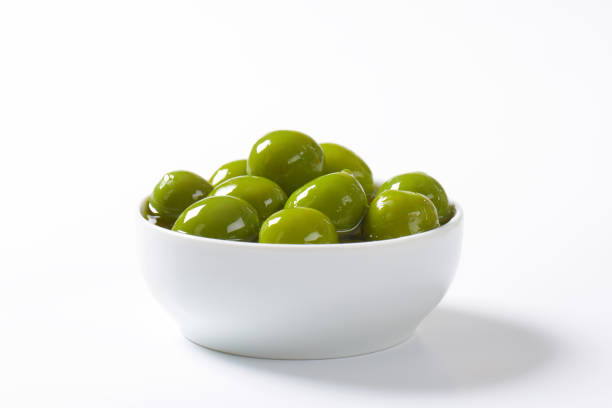 Bowl of green olives in oil