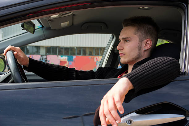 istock Handsome blond young man sitting in his car 534136885