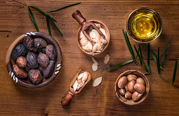Argan fruit and oil composition stock photo