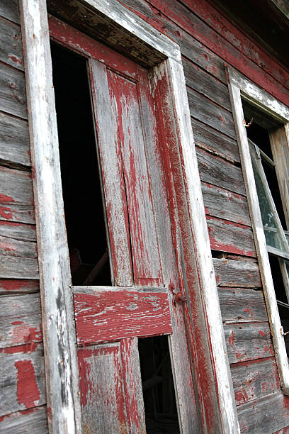 abandoned building with red peeling paint stock photo