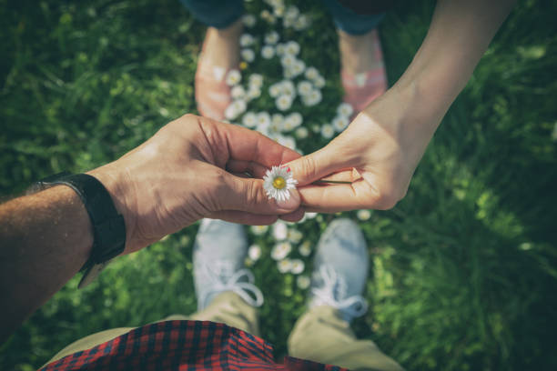 Couple sharing a flower in the park.