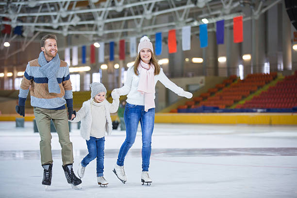 At ice-skating rink Family with child at ice-skating rink ice rink stock pictures, royalty-free photos & images