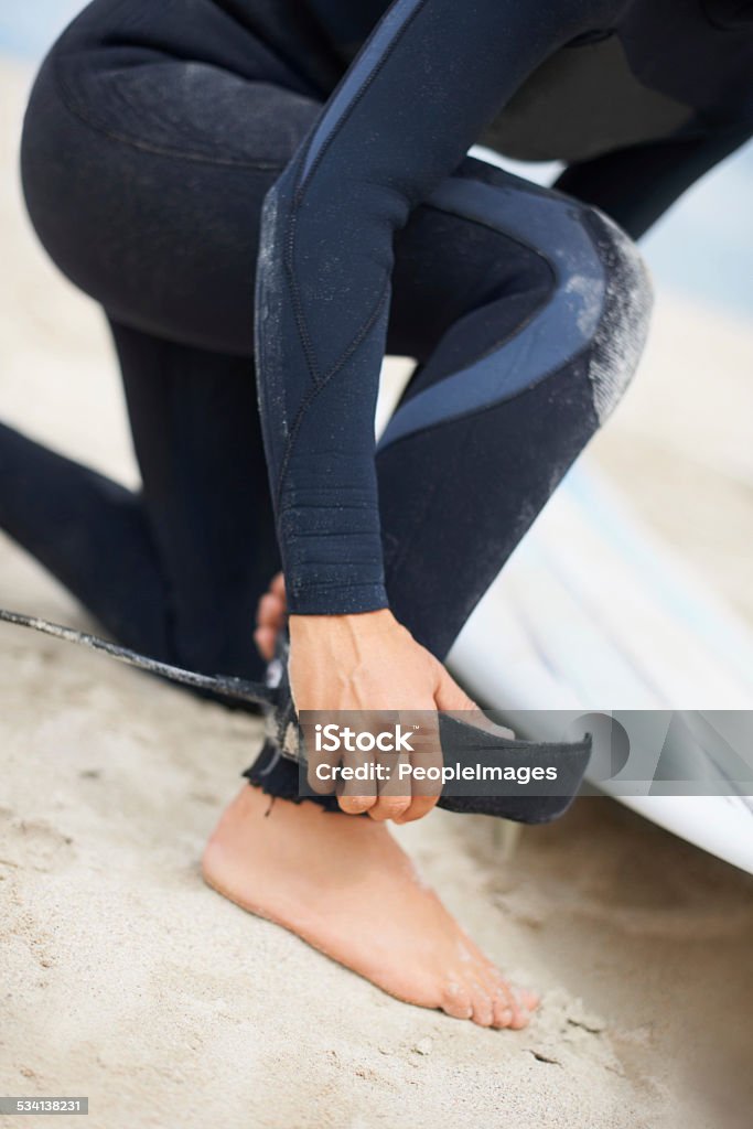 Almost ready Cropped shot of an unrecognizable female surfer attaching her surfboard to her anklehttp://195.154.178.81/DATA/shoots/ic_781661.jpg 2015 Stock Photo