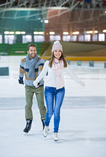 Active couple at skating rink