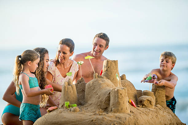 istock Happy family on vacation building a sand castle 534139201