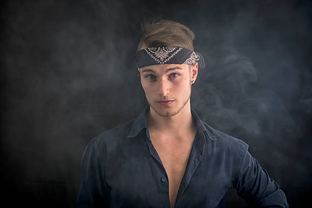 istock Handsome blond young man wearing bandana, smoke around him 534140309