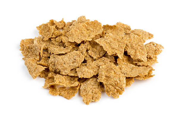istock Macro closeup of bran flakes isolated against white 534156149
