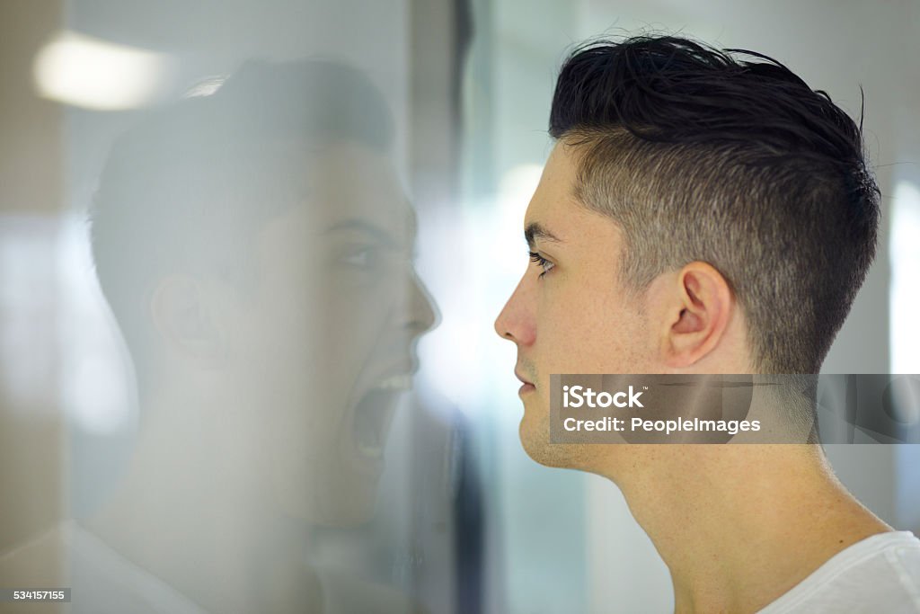 Screaming inside Young man looking at a screaming reflection of himself Demon - Fictional Character Stock Photo