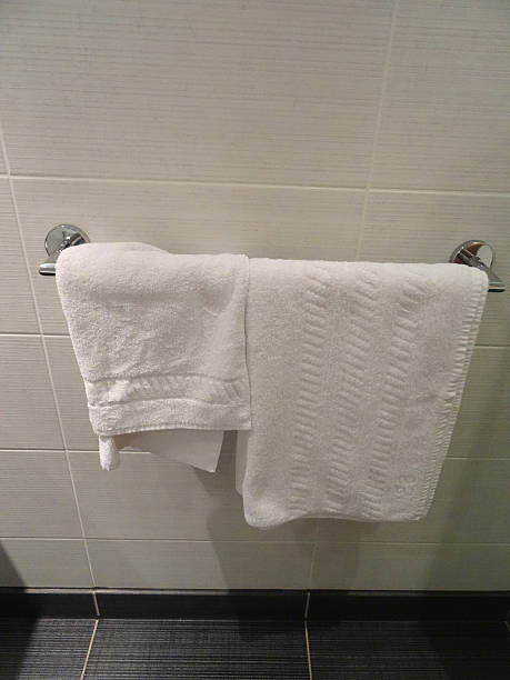 istock Bathroom tiles, fluffy white towels hanging on chrome towel rail 534158065