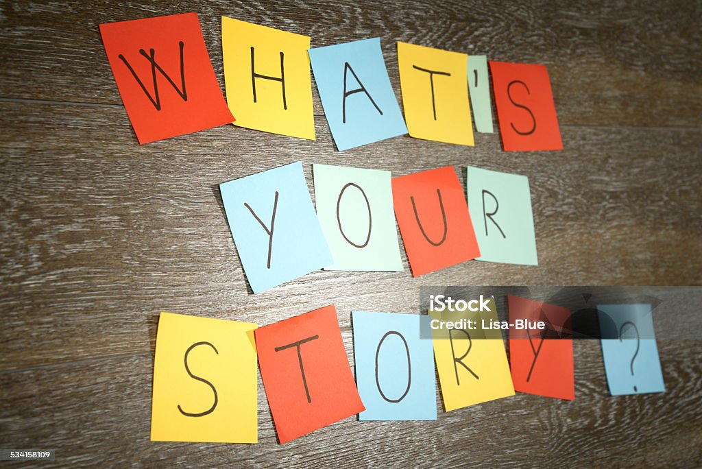 What's Your Story? What's your story question written on multicolored sticky notes. The adhesive notes are sticked on wooden plank blackground. Single Word Stock Photo