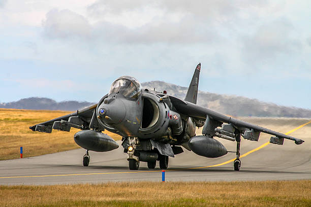 RAF Harrier An RAF Harrier taxiing for take of at RAF Valley, Anglesey, North Wales. raf stock pictures, royalty-free photos & images