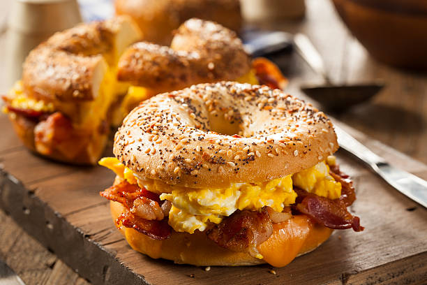 Hearty Breakfast Sandwich on a Bagel Hearty Breakfast Sandwich on a Bagel with Egg Bacon and Cheese sesame photos stock pictures, royalty-free photos & images