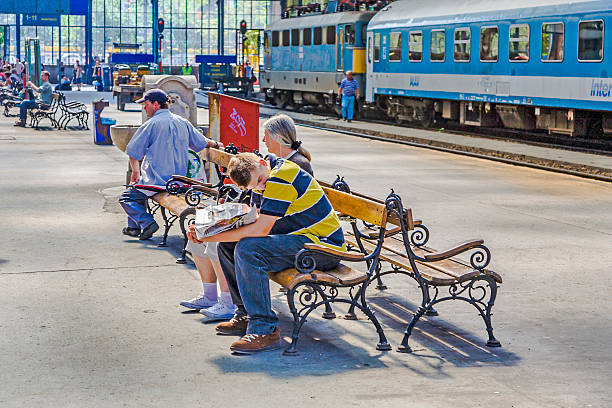 Budapest, Hungary - August 4, 2008: people wait for the train at platform of famous West Train Station  in Budapest, Hungary. The Station was constructed by Gustafe Eiffel.