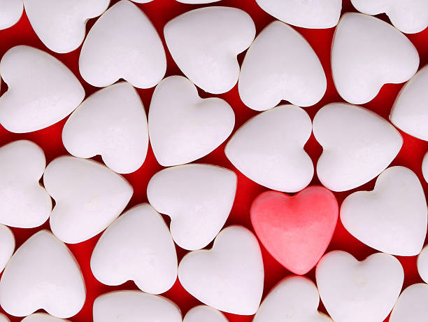 istock Pink heart between pile of white hearts. Candy Hearts background 534161265