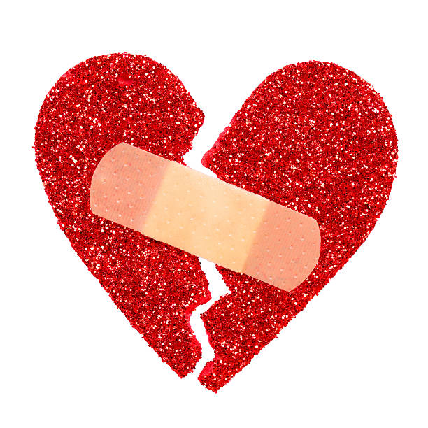 istock Broken Heart. Glitter ripped heart fixed with adhesive bandage isolated 534161291