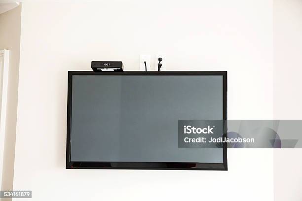 Flat Screen Television Mounted On Wall Stock Photo - Download Image Now - Apartment, Black Color, Cable