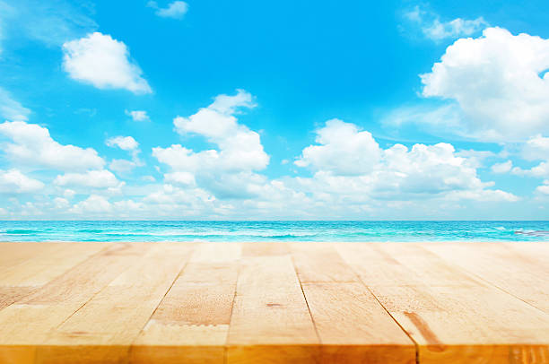 istock Wood table top on blue sea & sky background 534162283