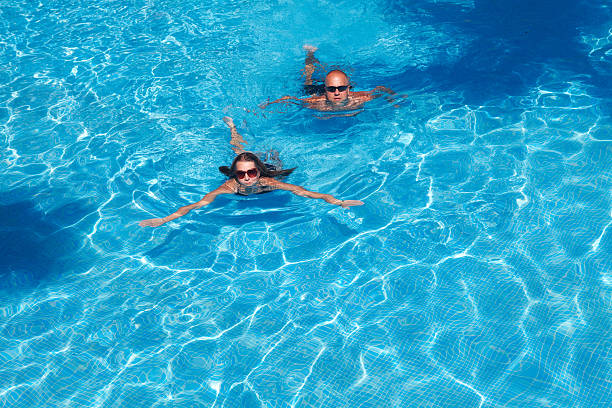 istock Couple swimming in pool 534165441