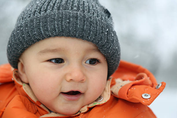istock Happy baby with snow in winter 534165553