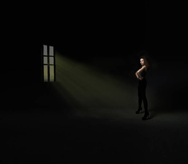 istock model in front of windon on a dark room 534193485