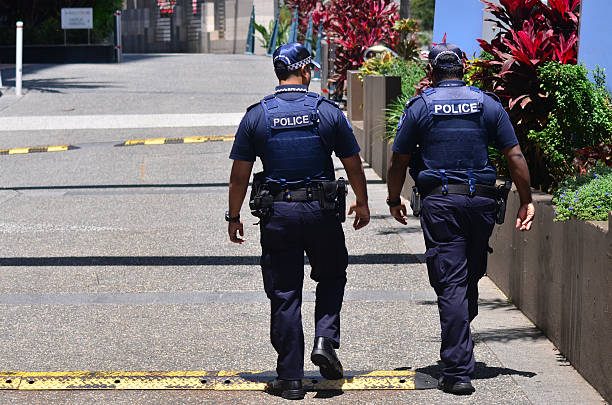 Queensland Police Service (QPS) -Australia Gold Coast, Australia - October 28, 2014: Police officers patrol the streets in Surfers Paradise. Gold Coast police on high terror alert warned to be hyper vigilant and patrol local mosques and critical infrastructure sites experiential travel stock pictures, royalty-free photos & images