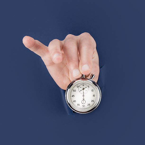 istock Male hand breaking through the blue paper antique clock 534195058
