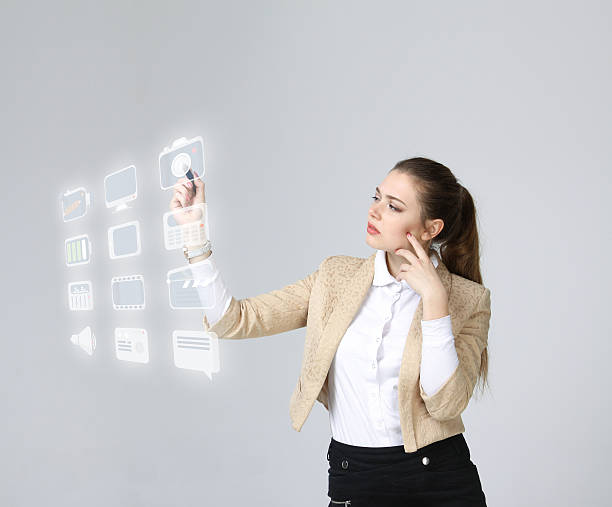 istock Woman pressing multimedia and entertainment icons on a virtual background 534195594