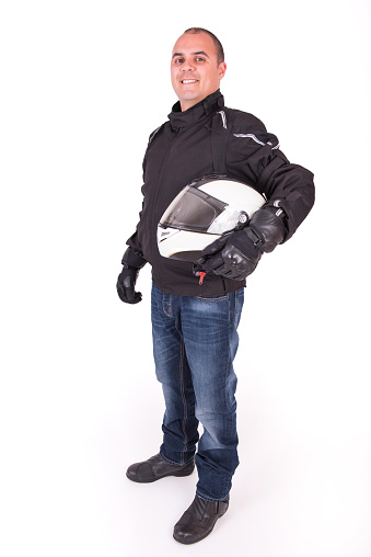 Biker holding his helmet under his arm on a white background