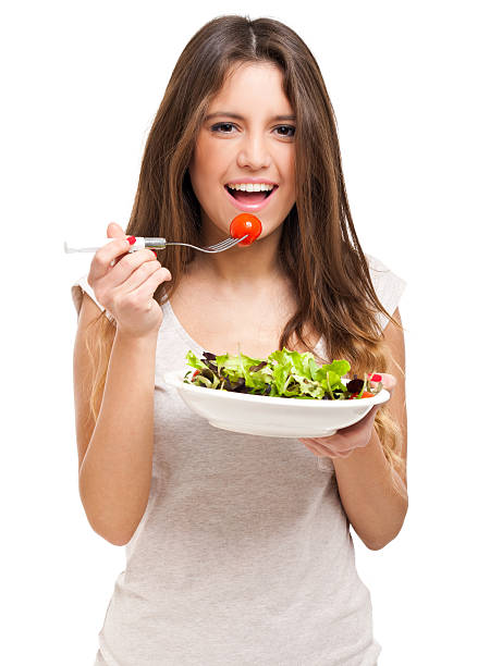 istock Young woman eating a healthy salad 534197843