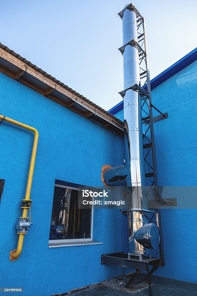 Smoke pipe on industrial building Smoke metal chrome pipe on industrial building 2015 Stock Photo