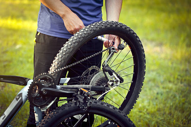 istock Man repairing a bike in the forest 534199794