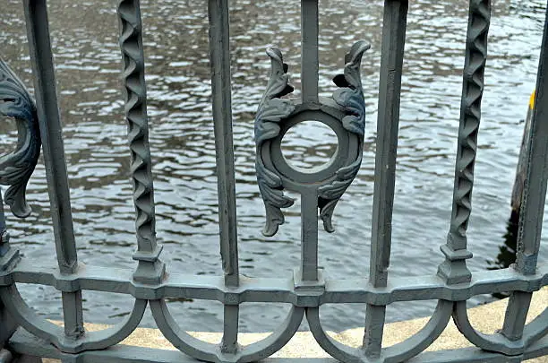 detail of an old bridge with decorated handrail.
