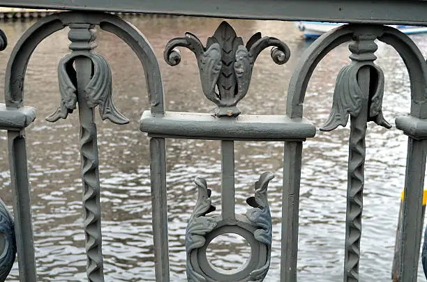 detail of an old bridge with decorated handrail.