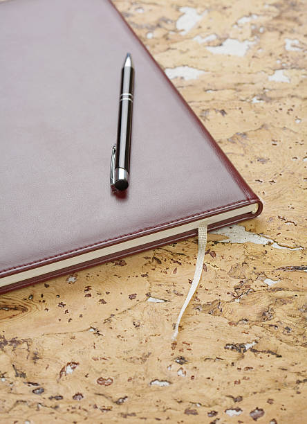 istock pen and diary on cork wood 534202290