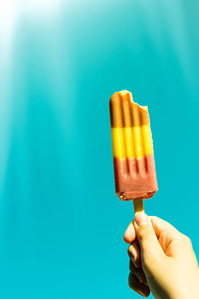 istock Hand holding a lollipop ice against the blue sky 534202338