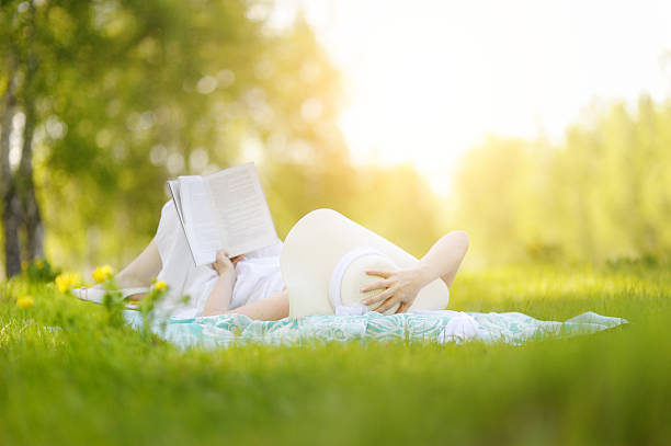 istock Young woman reading a book in the Park. 534203910