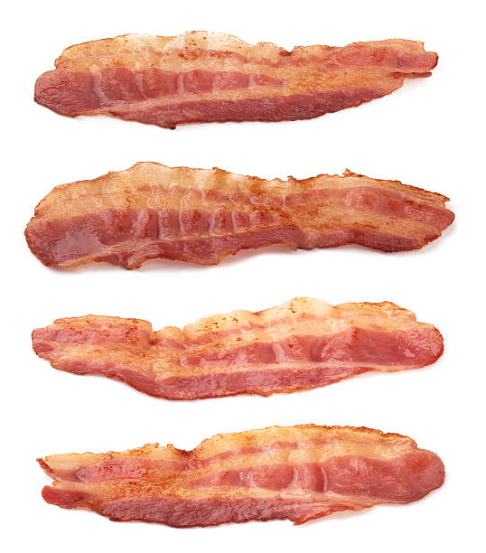 slices of bacon cooked slices of bacon isolated on white cooked bacon slice stock pictures, royalty-free photos & images